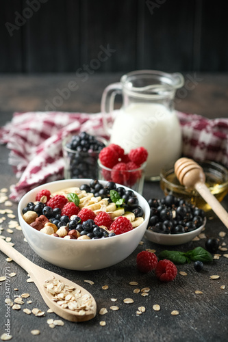 Oatmeal with berries and fruits on a light background. Healthy breakfast.