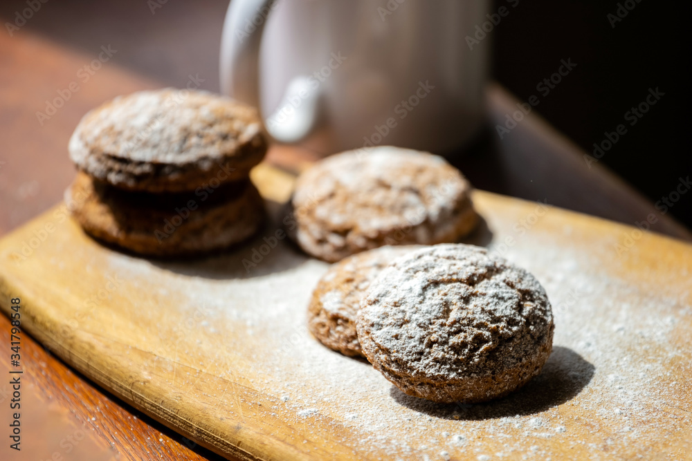 oatmeal cookies on a wooden board sprinkled with powdered sugar oatmeal cookies on a wooden board sprinkled with powdered sugar
