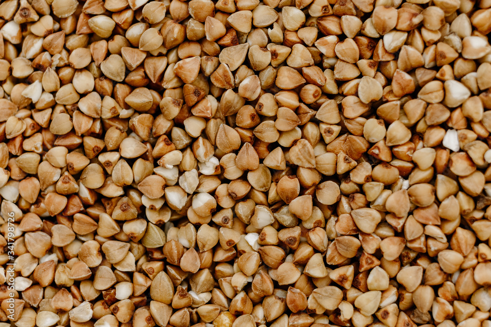Raw uncooked buckwheat grains texture, background Raw uncooked buckwheat grains texture, background