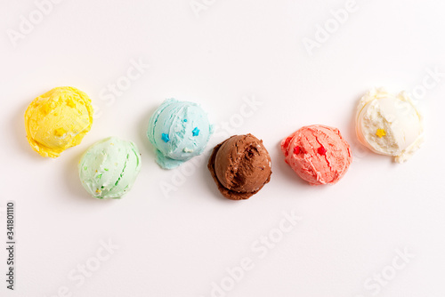 Colorful balls from freshly cooked homemade sweet ice-cream or gelato on a light grey background.