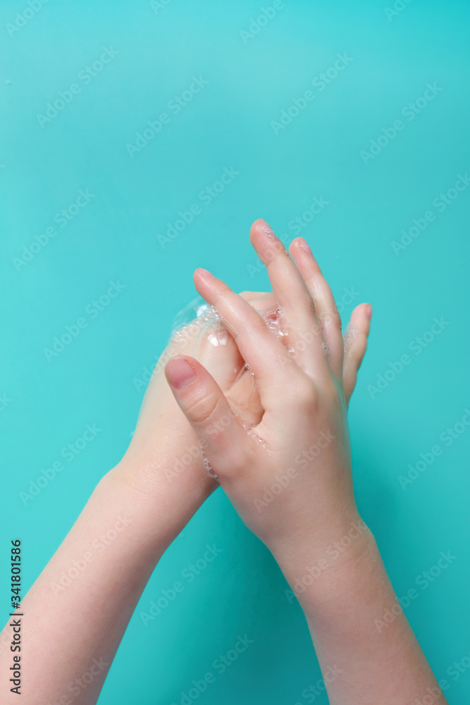 Wash your hands closeup of hands covered in soap suds, over blue. Wash your hands closeup of hands covered in soap suds, over blue.