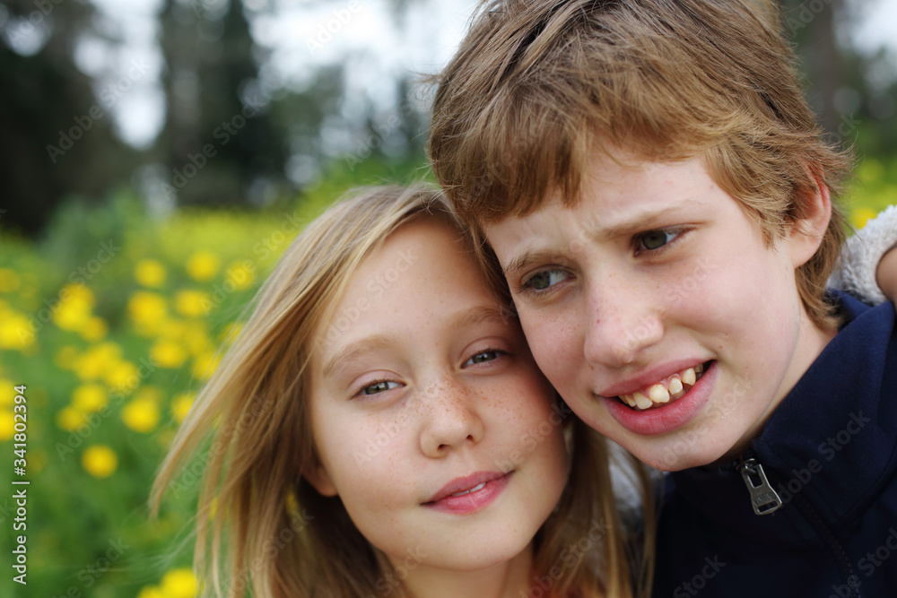 Portrait of sister with her autistic brother enjoying freedom and summer. Ending coronavirus quarantine, out of covid-19 quarantine. Portrait of sister with her autistic brother enjoying freedom and summer. Ending coronavirus quarantine, out of covid-19 quarantine.