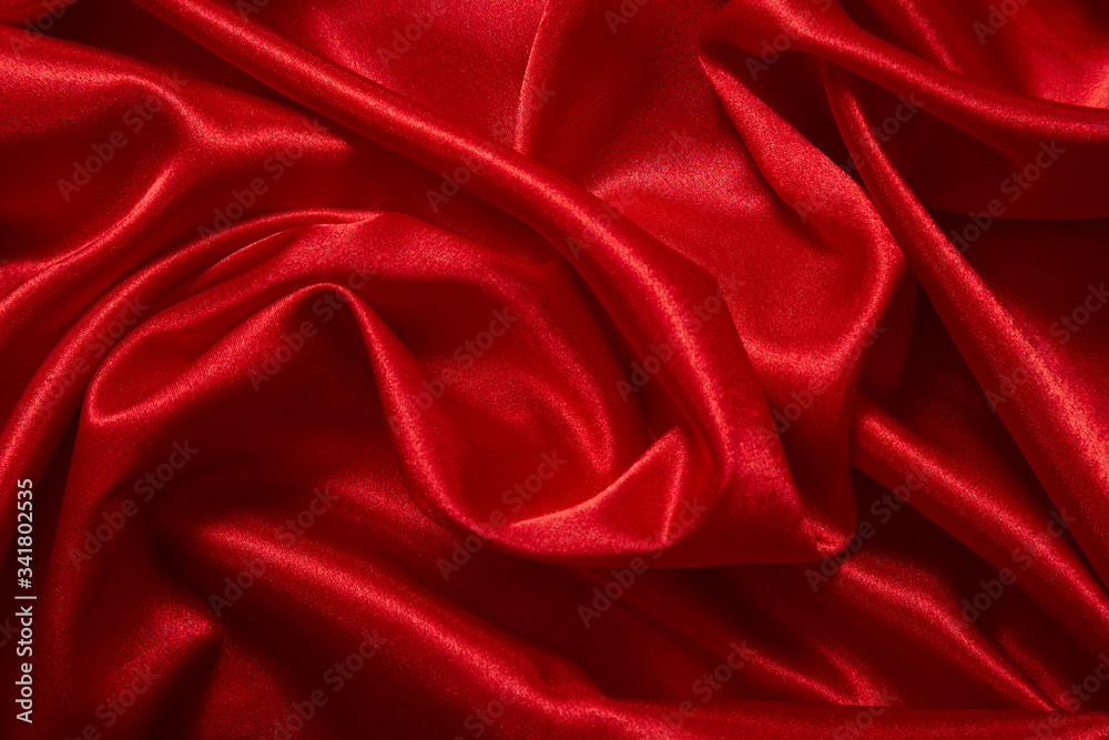 Fototapeta premium Luxury red satin smooth fabric background for celebration, ceremony, event invitation card or advertising poster