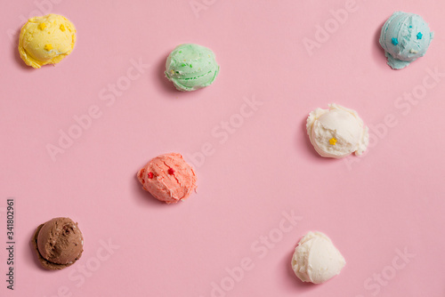 pattern of balls of natural colorful ice cream on a pink background