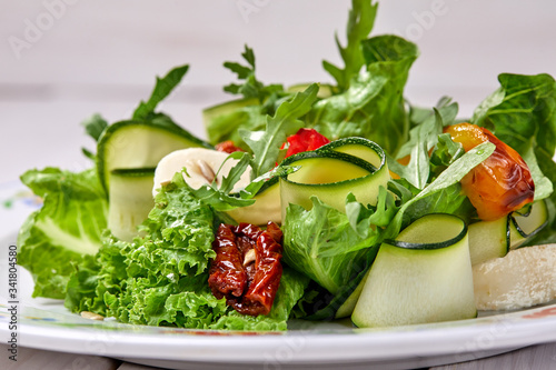 zucchini rolls with fresh salad photo