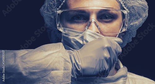 tired medical worker doctor nurse rips off a medical mask she is tired of quarantine, a huge flow of patients