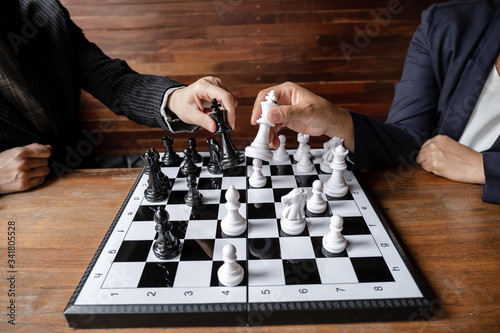 Business women play chess on board with white background, challenges planning business strategy to success concept