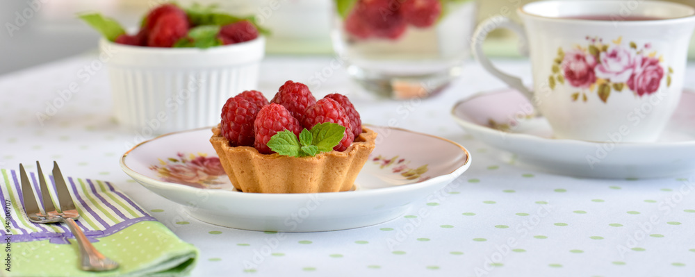 Mini tart with raspberries fruits on the table
Mini tart with raspberries fruits on the table