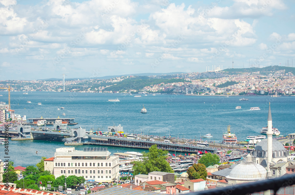Top view of Galata bridge, Golden Horn, Bosphorus in background. White pleasure ships. Seagulls flying over water. popular tourist destination. Red tiled roofs. Turkey, Istanbul Top view of Galata bridge, Golden Horn, Bosphorus in background. White pleasure ships. Seagulls flying over water. popular tourist destination. Red tiled roofs. Turkey, Istanbul