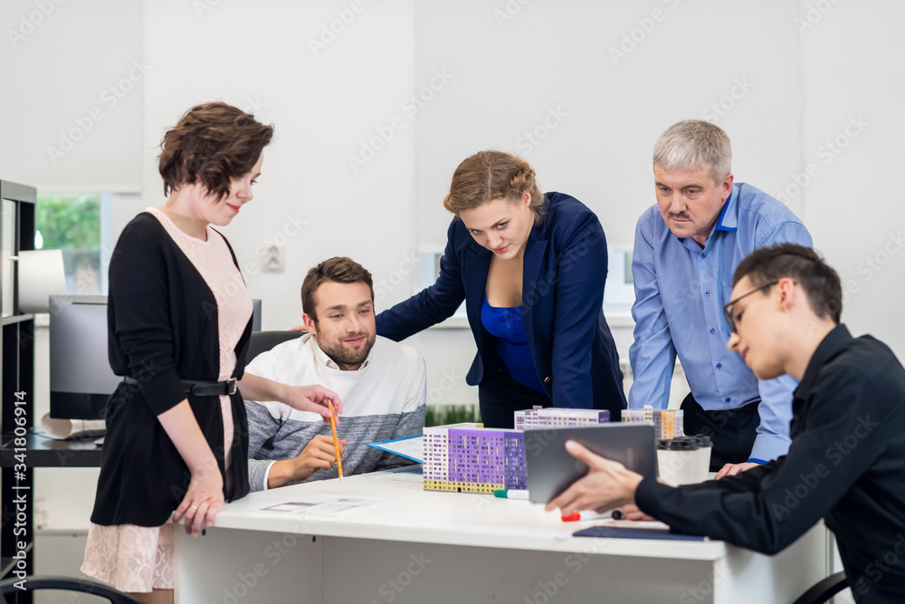 Project manager congratulating his team on the good job they have done. Everyone looks pleased with the presentation they have prepared Project manager congratulating his team on the good job they have done. Everyone looks pleased with the presentation they have prepared