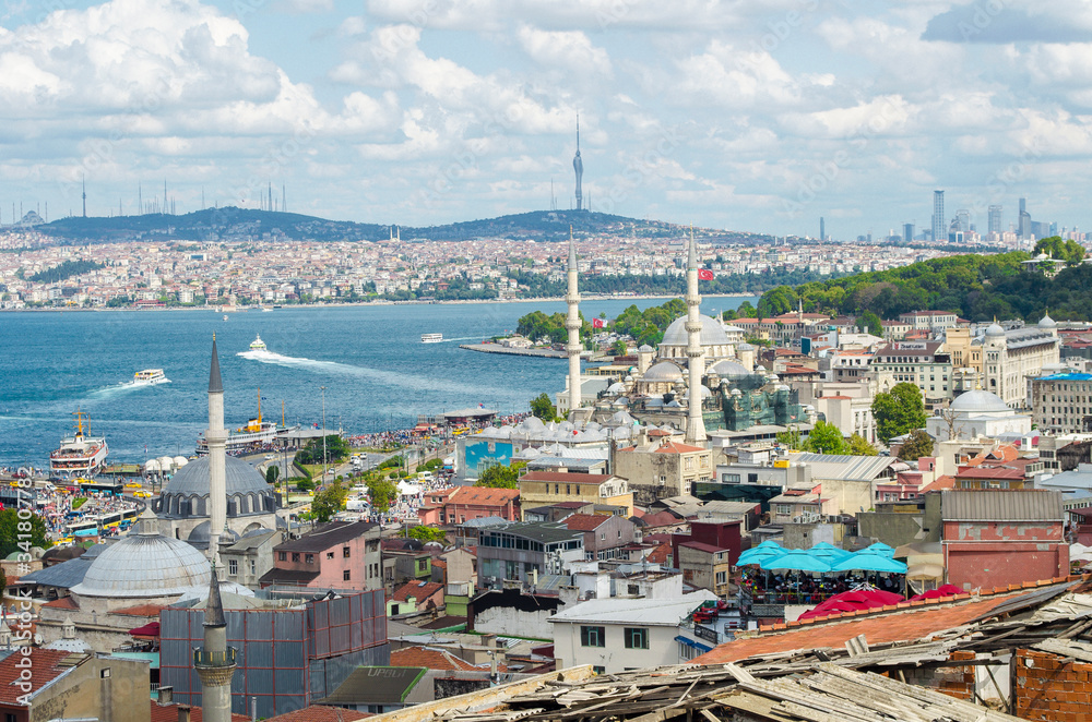 Top view. Golden Horn, Bosphorus in background. White pleasure ships. Seagulls flying over water. popular tourist destination. Red tiled roofs. Turkey, Istanbul