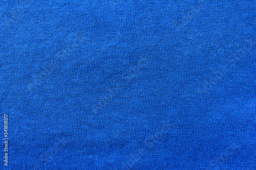 Colorful blue fabric background. Cotton natural texture. Blue colour blank seamless cloth. Vivid blue color fabric, thick material pattern. Unprinted blue canvas wallpaper