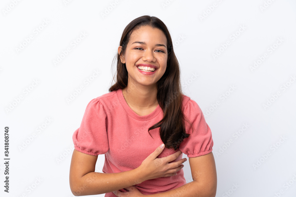 Young Colombian girl over isolated white background smiling a lot Young Colombian girl over isolated white background smiling a lot