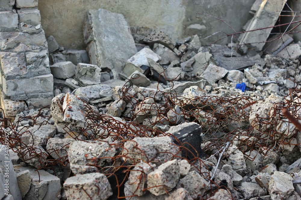 Destroyed brick walls of houses with rusty iron structural elements Destroyed brick walls of houses with rusty iron structural elements