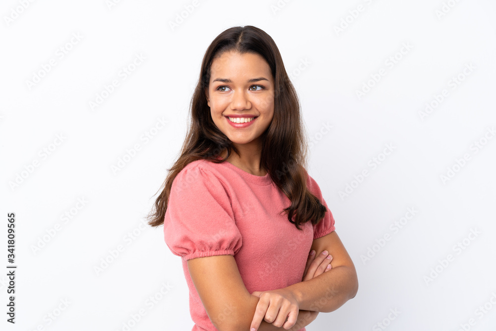 Young Colombian girl over isolated white background with arms crossed and happy Young Colombian girl over isolated white background with arms crossed and happy