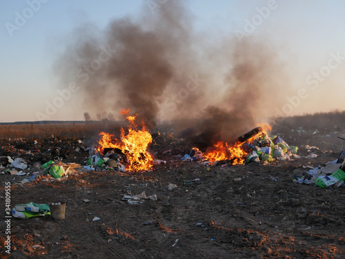 puffs of smoke from the trash. burning garbage. concern for the environment. environmental pollution.