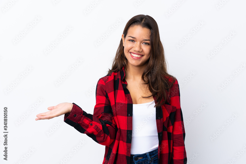 Young Colombian girl over isolated white background holding copyspace imaginary on the palm Young Colombian girl over isolated white background holding copyspace imaginary on the palm