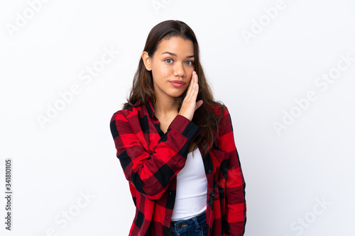 Young Colombian girl over isolated white background whispering something