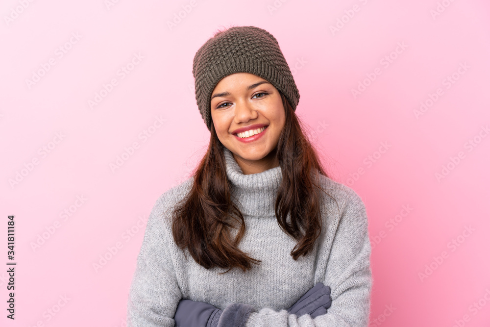 Young Colombian girl with winter hat over isolated pink wall laughing Young Colombian girl with winter hat over isolated pink wall laughing