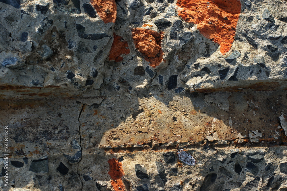 Fototapeta premium Destroyed brick walls of houses with rusty iron structural elements