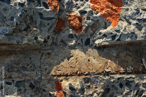 Destroyed brick walls of houses with rusty iron structural elements