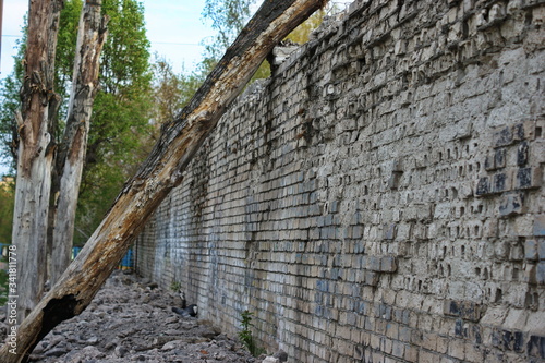 Destroyed brick walls of houses with rusty iron structural elements