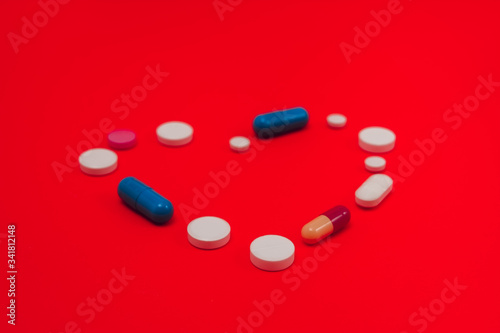Heart Made From Capsules Over Blue Background