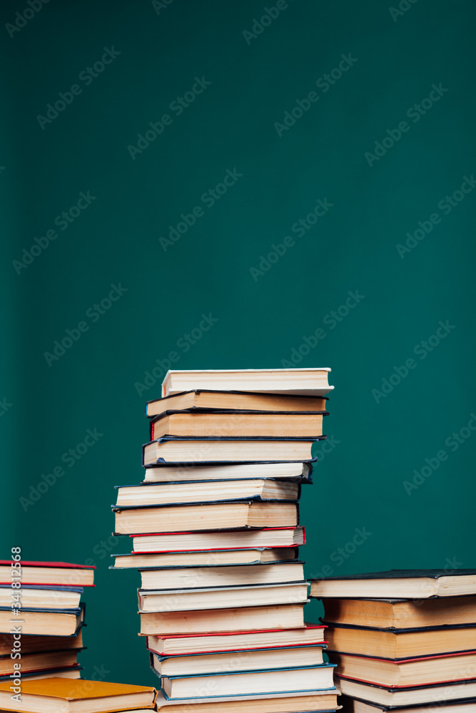 many stacks of educational books in the university library on a green background many stacks of educational books in the university library on a green background