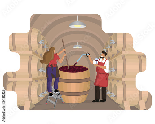 Male winemaker checks wine during fermentation process and female winemaker mixes and shakes grape pulp in large wooden vat at wine cellar with oak barrels.