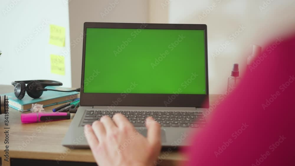 Work from home man typing on laptop with green screen on table internet computer online business display people network digital monitor slow motion