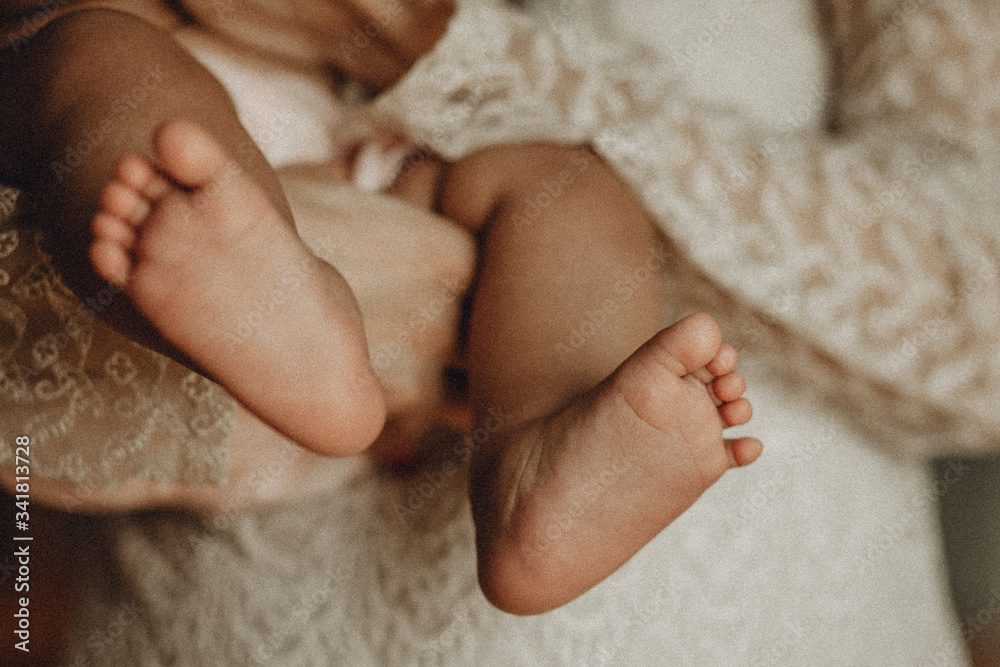 The foot of a child on the mother hand The foot of a child on the mother hand