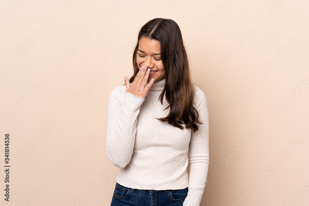 Young Colombian girl over isolated background smiling a lot Young Colombian girl over isolated background smiling a lot