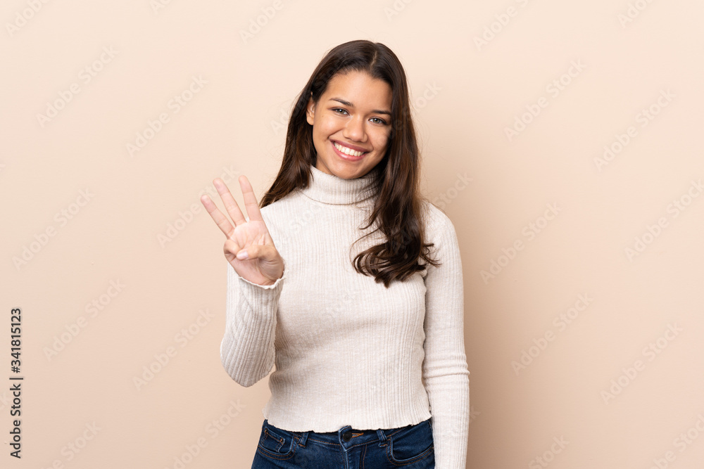 Young Colombian girl over isolated background happy and counting three with fingers Young Colombian girl over isolated background happy and counting three with fingers