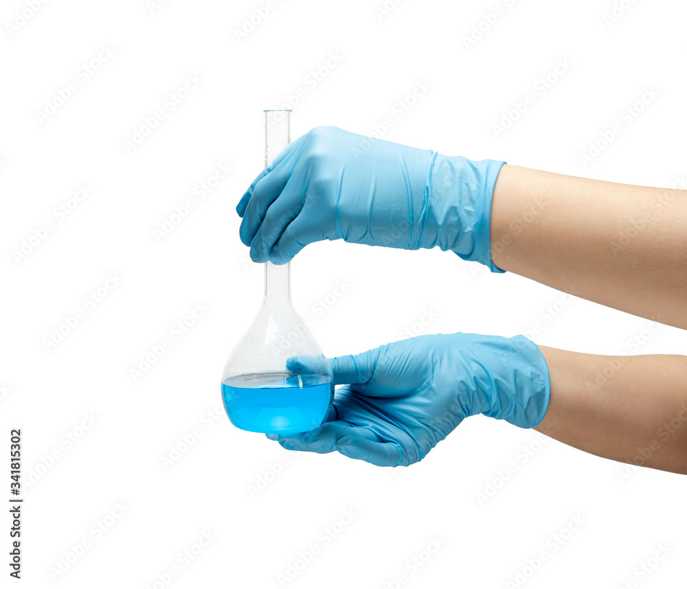 Female hands in a blue rubber glove holds a flask of blue medicine on white background isolate. Female hands in a blue rubber glove holds a flask of blue medicine on white background isolate.
