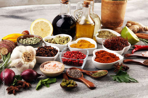 Fototapeta Naklejka Na Ścianę i Meble -  Spices and herbs on table. Food and cuisine ingredients with oil and vinegar
