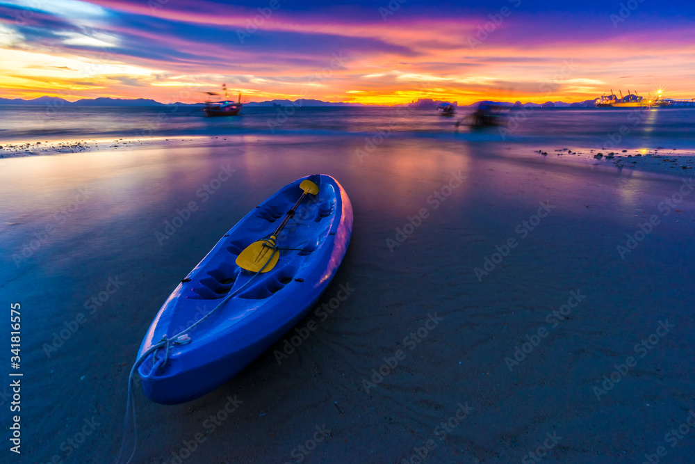 sea kayaks on the beach at sunset