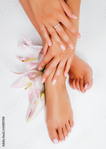 manicure pedicure with flower lily closeup isolated on white perfect shape hands spa salon