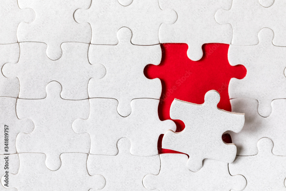 White jigsaw puzzle. White puzzle pieces on color background. Unfinished white jigsaw puzzle pieces on color background. White jigsaw puzzle. White puzzle pieces on color background. Unfinished white jigsaw puzzle pieces on color background.