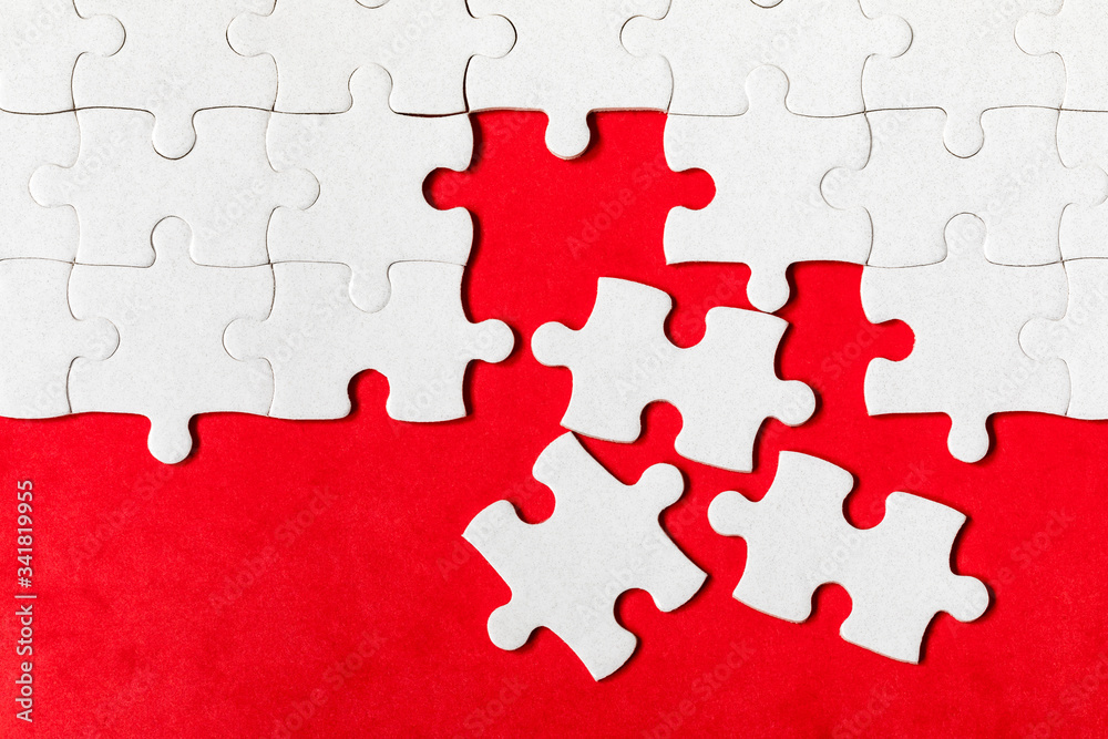 White jigsaw puzzle. White puzzle pieces on color background. Unfinished white jigsaw puzzle pieces on color background. White jigsaw puzzle. White puzzle pieces on color background. Unfinished white jigsaw puzzle pieces on color background.