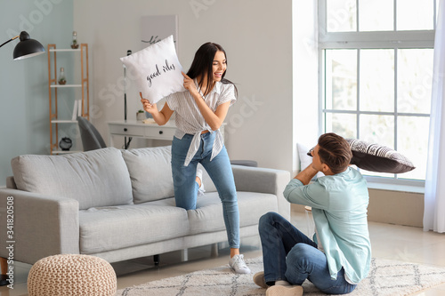 Happy young couple fighting...