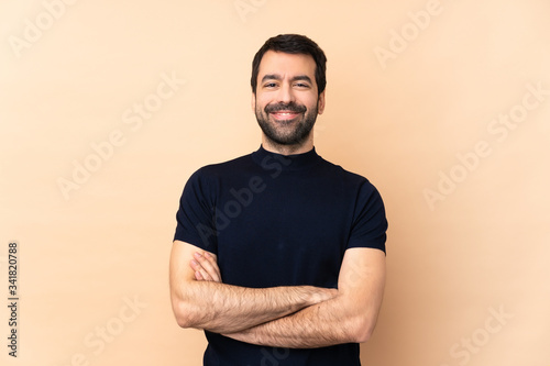Caucasian handsome man over isolated background keeping the arms crossed in frontal position