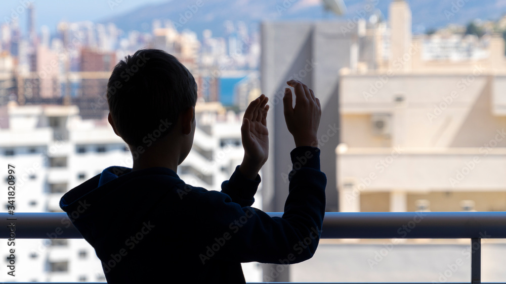 Applause to medical staff. Kid clapping hands, applauding from balcony to support doctors, nurses, hospital workers during Coronavirus pandemic quarantine Applause to medical staff. Kid clapping hands, applauding from balcony to support doctors, nurses, hospital workers during Coronavirus pandemic quarantine