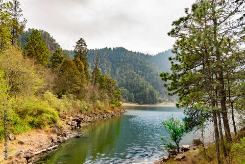 Lake in the forest with mountains in a cloudy day