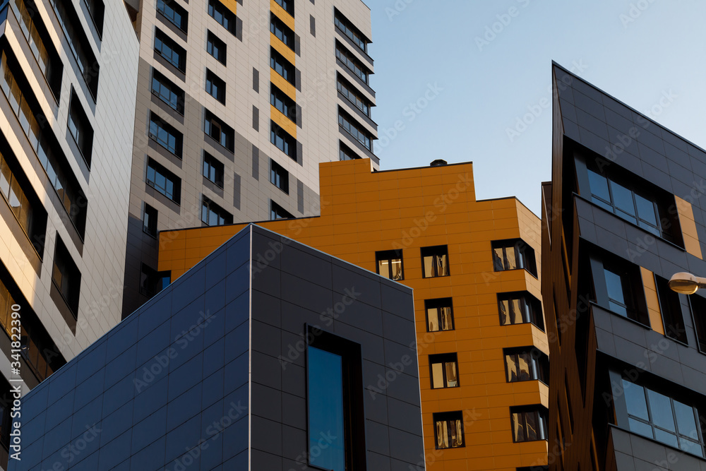 Part of urban real estate. Modern ventilated facade with windows. Diagonal arrangement.