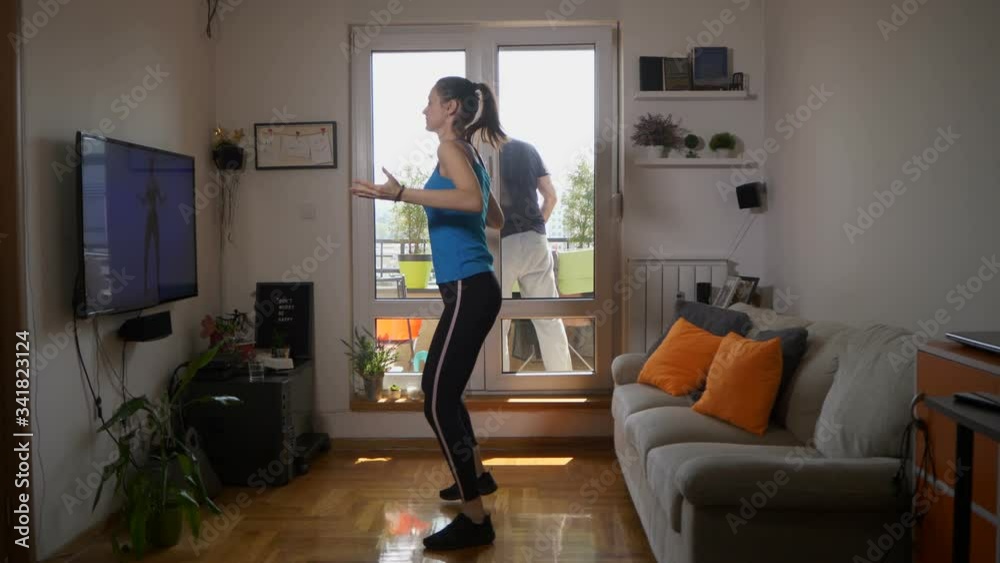 Dance workout at home, woman exercising in front of tv