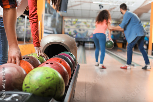 Friends playing bowling in ...