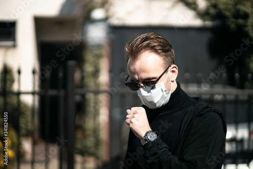 sick man coughing with sore throat; concept of man with allergy, phlegm, sore throat or throat inflammation, influenza, flu, cold, sickness, health care concept using medical mask corona covid-19