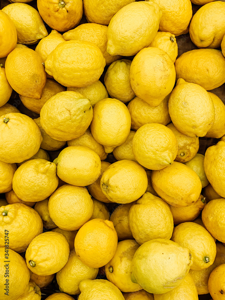lots of ripe fruit yellow lemons for eating a background