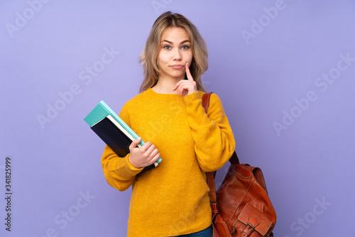 Teenager Russian student girl isolated on purple background and looking front
