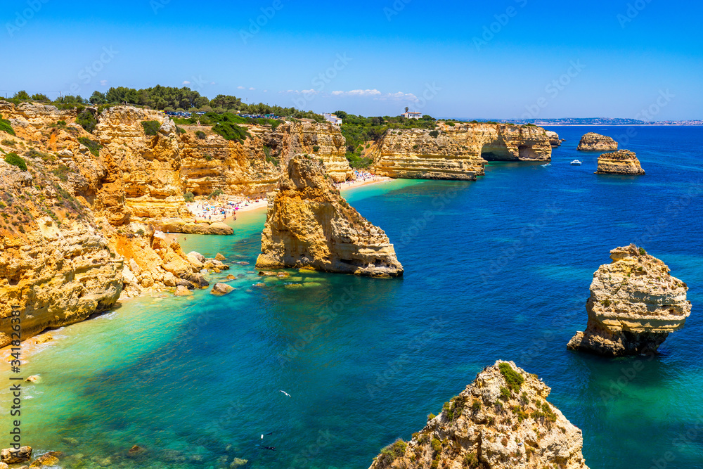Fototapeta premium Praia da Marinha, beautiful beach Marinha in Algarve, Portugal. Navy Beach (Praia da Marinha), one of the most famous beaches of Portugal, located on the Atlantic coast in Lagoa Municipality, Algarve.